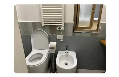 a small bathroom with a toilet and a sink at Les Artes in Rome