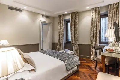 a hotel room with a bed and a desk at Hotel Lunetta in Rome