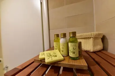 two bottles of vinegar and a piece of cheese on a wooden table at QuodLibet in Rome