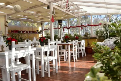 a dining room with white tables and white chairs at QuodLibet in Rome