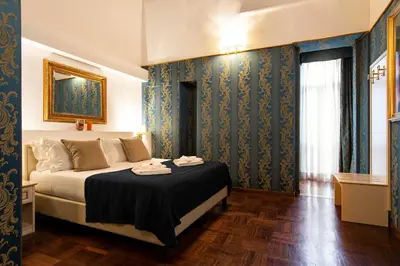 a bedroom with a bed with a black blanket at Canova Rooms in Spanish Steps in Rome