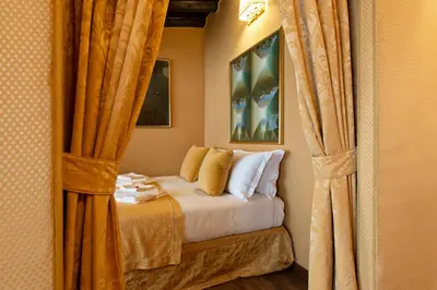a bedroom with a bed with yellow curtains at Canova Rooms in Spanish Steps in Rome