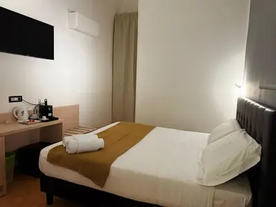 a hotel room with a bed and a desk at Conte GuestHouse in Rome