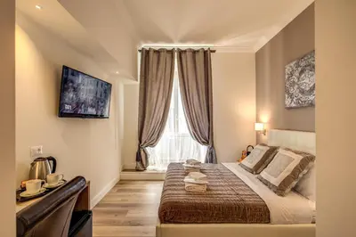 a bedroom with a large bed and a window at Chester Suites in Rome