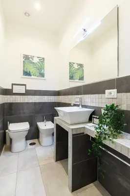 a bathroom with a sink and a toilet and a mirror at Aeterna Rooms Collection GuestHouse in Rome