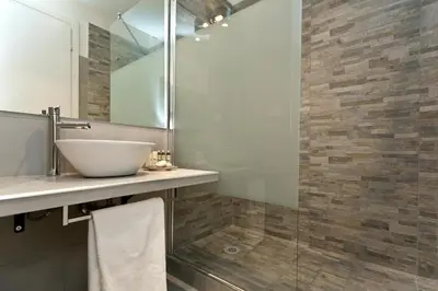 a bathroom with a sink and a glass shower at Aeterna Rooms Collection GuestHouse in Rome