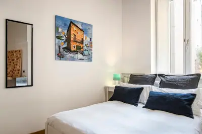 a bedroom with two beds and a picture on the wall at Imperial Loft in Rome