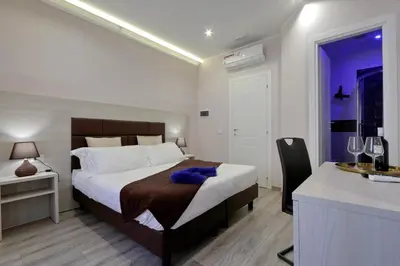 a bedroom with a large bed and a sink at Roma Suite Monti in Rome