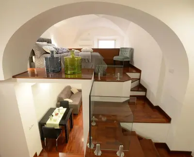 a living room with a glass table and a couch at Home Alex in Rome