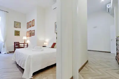 a white bedroom with a bed in a room at Sistina 2 in Rome