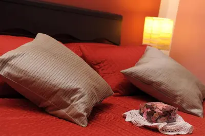 a bed with two pillows and a hat on it at B&B Alexander in Rome