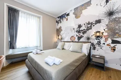 a bedroom with a bed with towels on it at Castro Pretorio in Rome