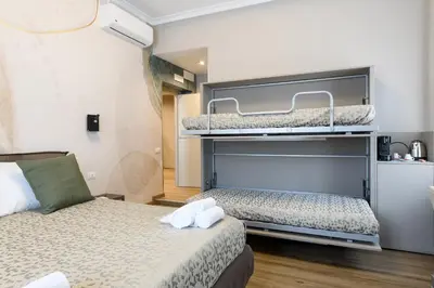 two beds in a room with two bunk beds at Castro Pretorio in Rome