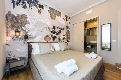 a bedroom with a bed with towels on it at Castro Pretorio in Rome