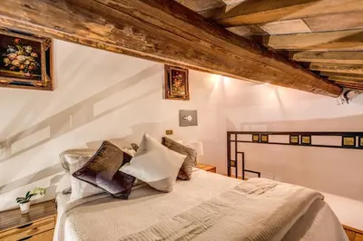 a bedroom with a bed in a room with wooden ceilings at FRESH HOUSE TREVI 2 in Rome