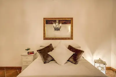 a bedroom with a bed with a picture on the wall at FRESH HOUSE TREVI 2 in Rome