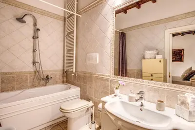 a bathroom with a toilet and a sink and a tub at FRESH HOUSE TREVI 2 in Rome