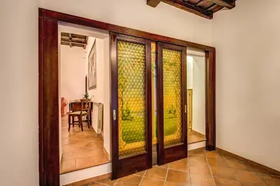 a room with sliding glass doors with a table at FRESH HOUSE TREVI 2 in Rome