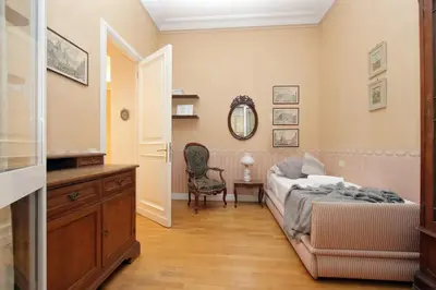 a bedroom with a bed and a dresser and a mirror at Vatican House Via Terenzio in Rome