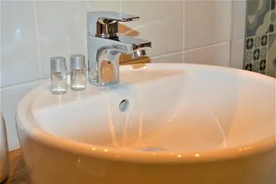 a sink with a faucet in a bathroom at romantica guest house in Rome