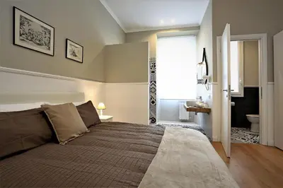 a bedroom with a large bed and a bathroom at romantica guest house in Rome