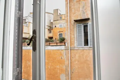 an open window with a view of a building at SuityRHome RioneMonti37 in Rome