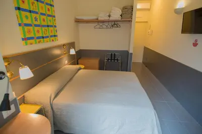 a bedroom with a large bed and a television at tiaspettoaroma in Rome