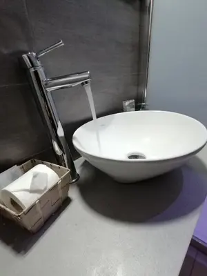 a bathroom with a white sink and a box of tissues at Chroma Italy - Chroma Deka in Rome
