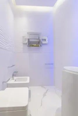 a white bathroom with a toilet and a sink at LUX Suites in Roma in Rome
