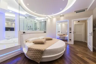 a bedroom with a large bed and a bath tub at LUX Suites in Roma in Rome
