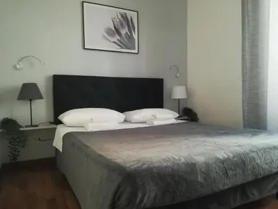 a bedroom with a bed with a black and white comforter at Vatican Area House in Rome