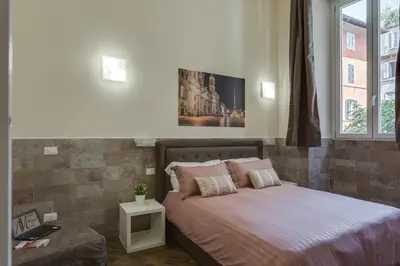 a bedroom with a bed with a picture on the wall at Navona Charme Suite in Rome
