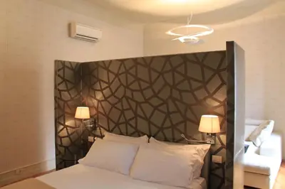a bedroom with a bed with a black headboard at Sweet Vatican in Rome