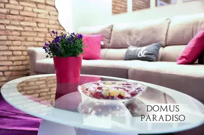 a coffee table with a bowl of candy and flowers on it at Domus Paradiso in Piazza Navona in Rome