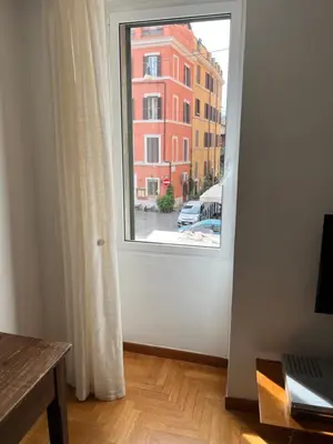 an open door with a view of a building at Sunny Side Trastevere in Rome
