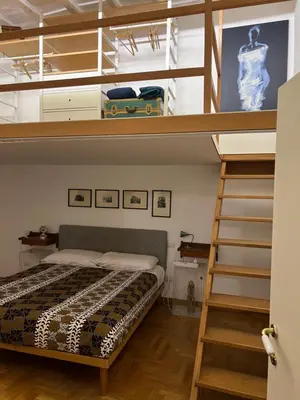 a bedroom with a bunk bed and a ladder at Sunny Side Trastevere in Rome