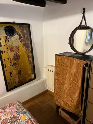 a room with a mirror and a painting on the wall at Sunny Side Trastevere in Rome