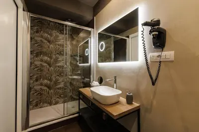 a bathroom with a sink and a shower at Il Corso Comfort Rooms in Rome