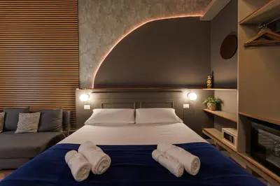 a bedroom with a bed with two towels on it at Il Corso Comfort Rooms in Rome