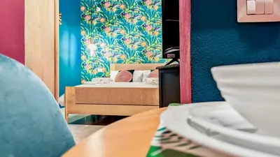 a room with a table and a bed in a room at Colosseum Charme Apartments in Rome