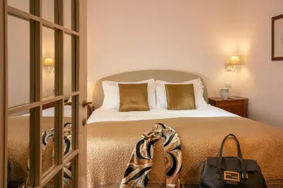 a bedroom with a bed with a bag on it at Riccardo Condotti Suite in Rome
