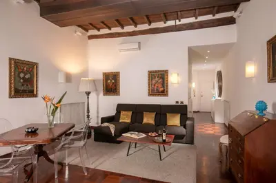 a living room with a couch and a table at Riccardo Condotti Suite in Rome