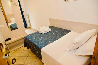 a hotel room with a bed and a mirror at Albergo Marechiaro in Rome