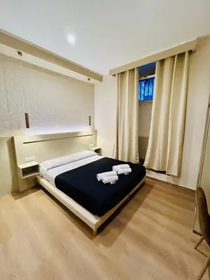 a bedroom with a large bed with towels on it at ImeraRooms in Rome
