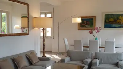 a living room with chairs and a table and a mirror at Rental in Rome Colosseo View Luxury in Rome