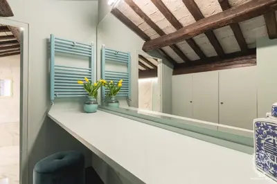 a kitchen with a long counter with blue windows at Residenza Spada in Rome