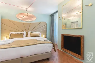a bedroom with a large bed and a fireplace at Residenza Spada in Rome
