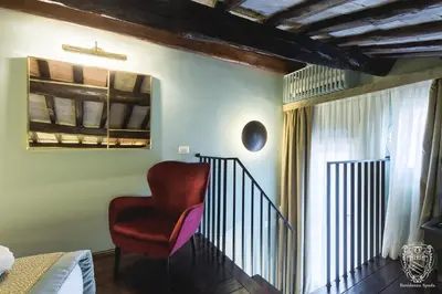 a red chair sitting on the stairs in a room at Residenza Spada in Rome