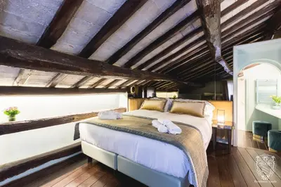 a bedroom with a large bed in a room with wooden ceilings at Residenza Spada in Rome