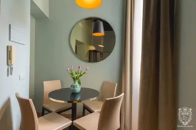 a dining room with a table and chairs and a mirror at Residenza Spada in Rome